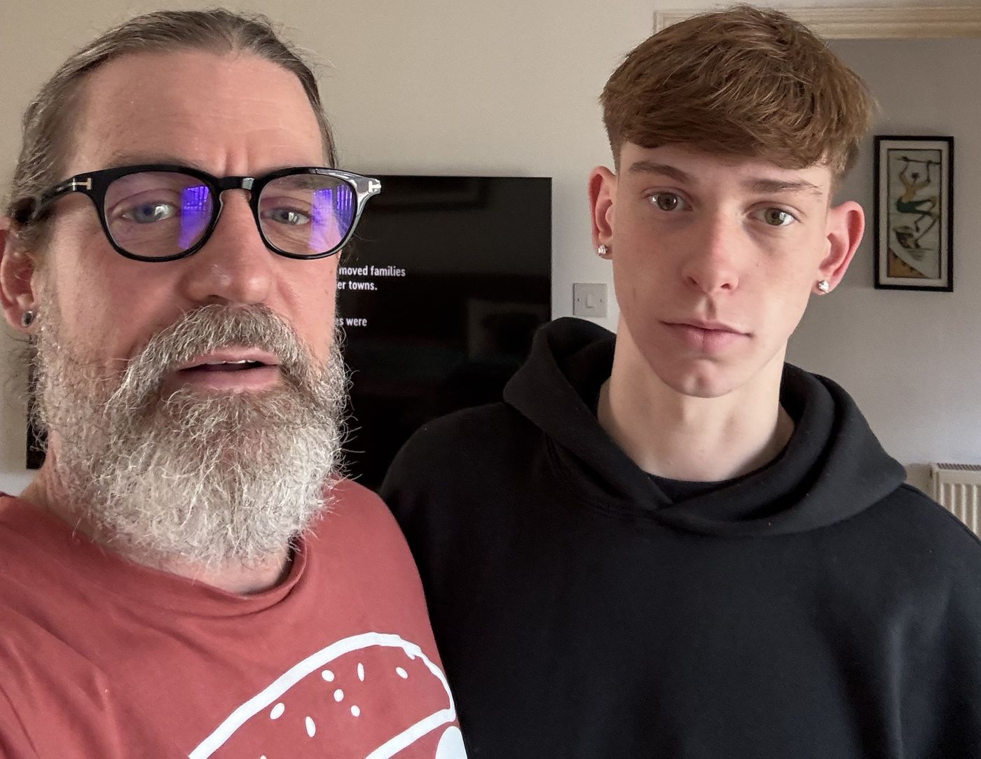 Jason and his son Nathan standing side by side at home